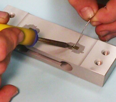 strain gages being soldered to material