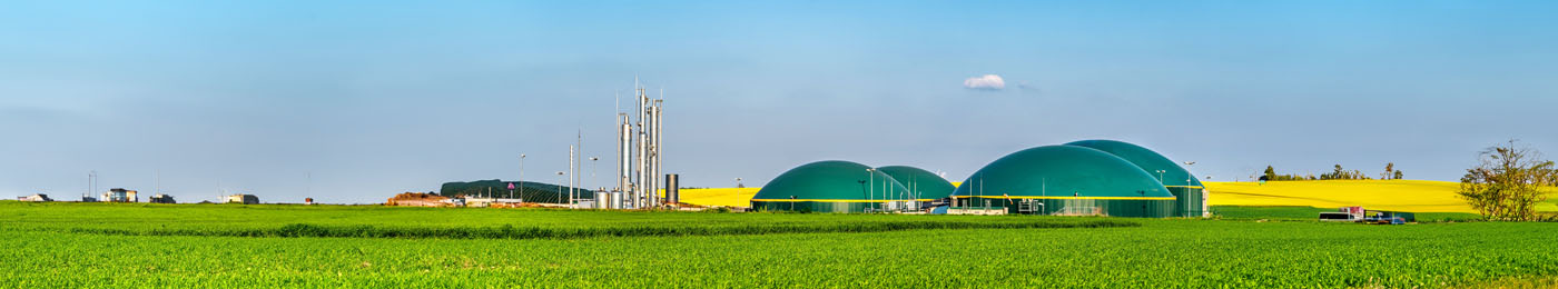 Modern biogas plant between several fields in rural region