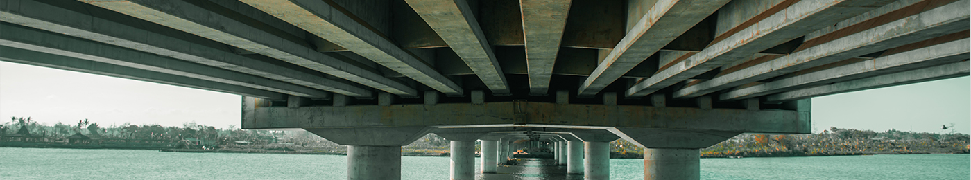 the underside of a bridge spanning a river