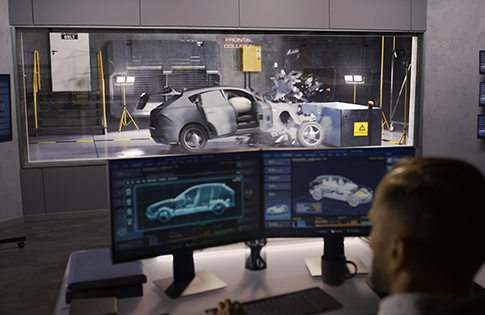 engineer at computer monitoring a vehicle crash test