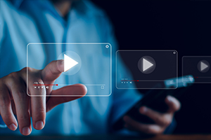 a  man pressing play on a video icon floating in the air