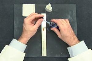 hands installing strain gage